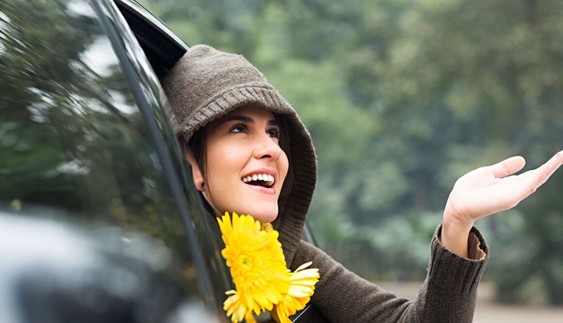 Woman looking out from car window in rain