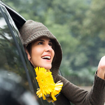 Woman looking out from car window in rain