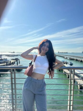 chavi khattar standing by the pool side in dubai in white top grey pants